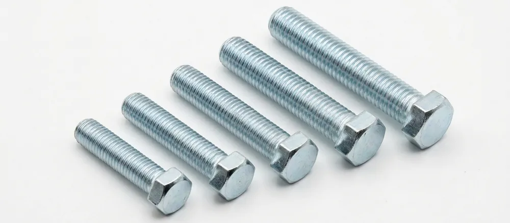 Bright zinc hex setscrews in a stepped row, threads pointing to the top left