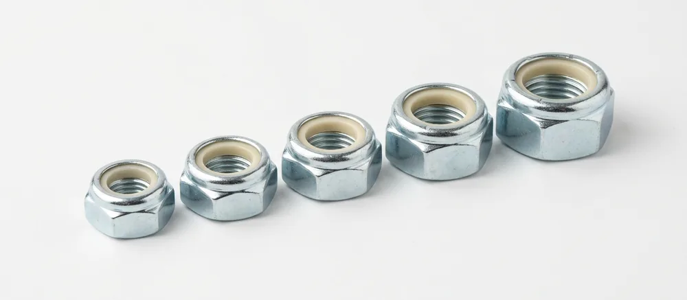Imperial nyloc nuts with natural cream nylon inserts in a stepped row